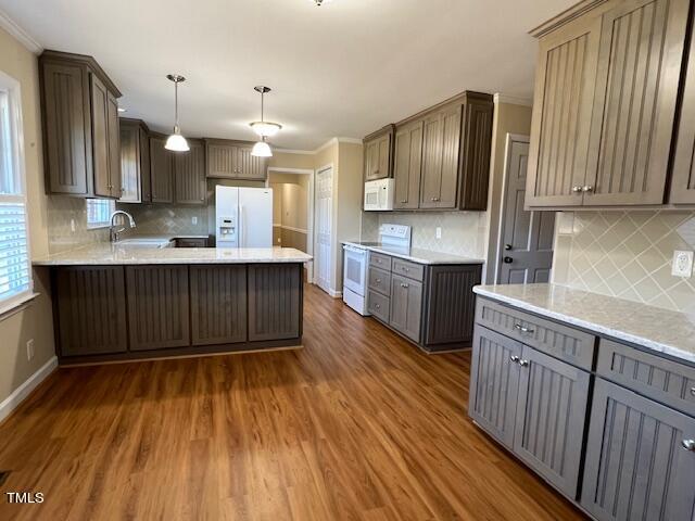 971 Rock Spring Church Road Henderson, NC 27537 - Photo 7 of 39 a large kitchen with wooden floors and stainless steel appliances
