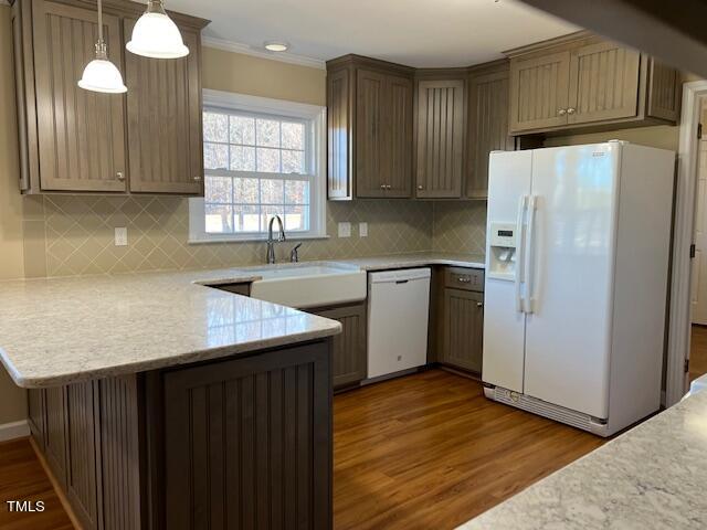 971 Rock Spring Church Road Henderson, NC 27537 - Photo 9 of 39 a kitchen with stainless steel appliances granite countertop a refrigerator a sink dishwasher and wooden cabinets with wooden floor