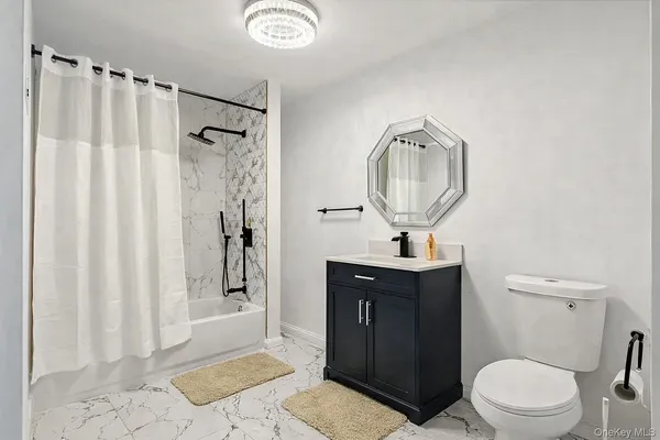 a bathroom with a toilet a sink and a shower