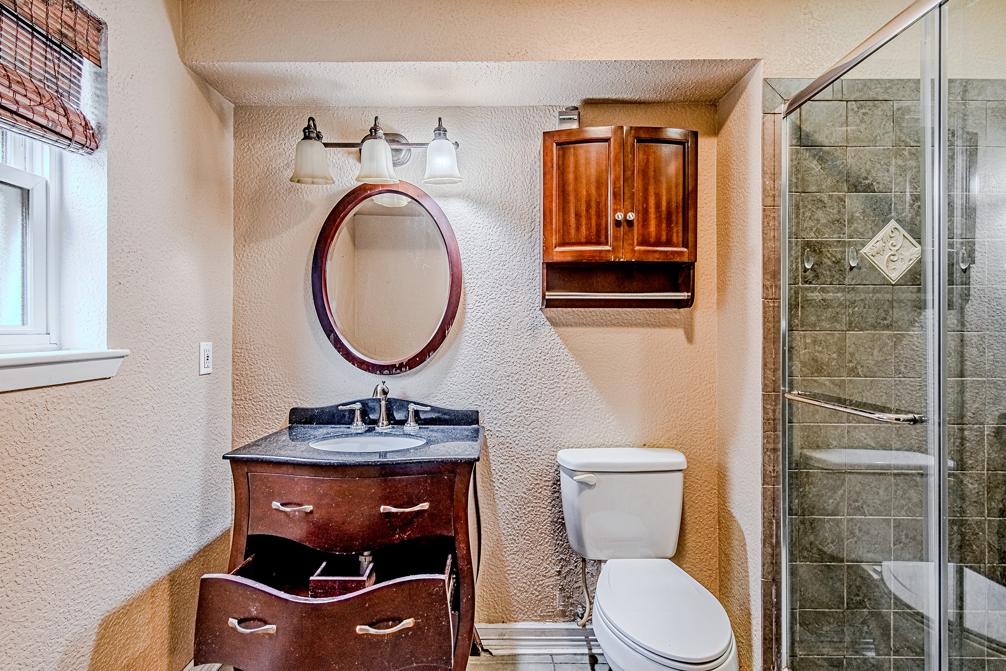 2710 Burke Road Pasadena, TX 77502 - Photo 17 of 28 Updated primary bathroom featuring vanity and tiled walk-in shower