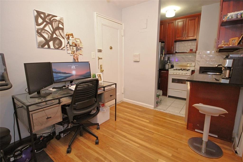 7259 Shore Road, Unit 5A Brooklyn, NY 11209 - Photo 13 of 18 a view of a workspace with furniture and wooden floor