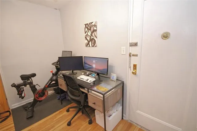 a view of workspace with wooden floor windows
