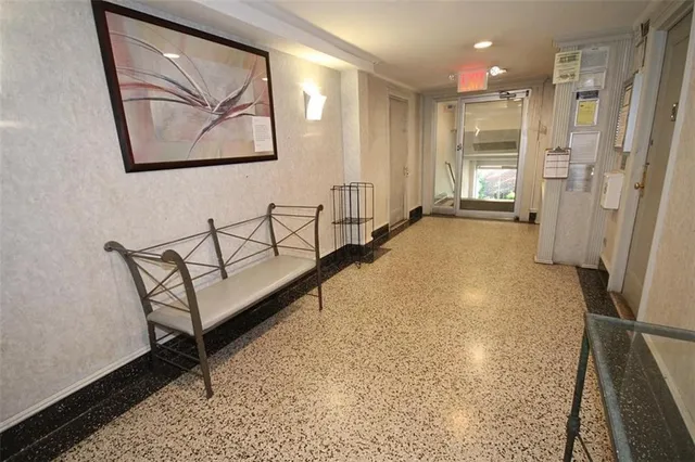 a view of a hallway with a wooden door