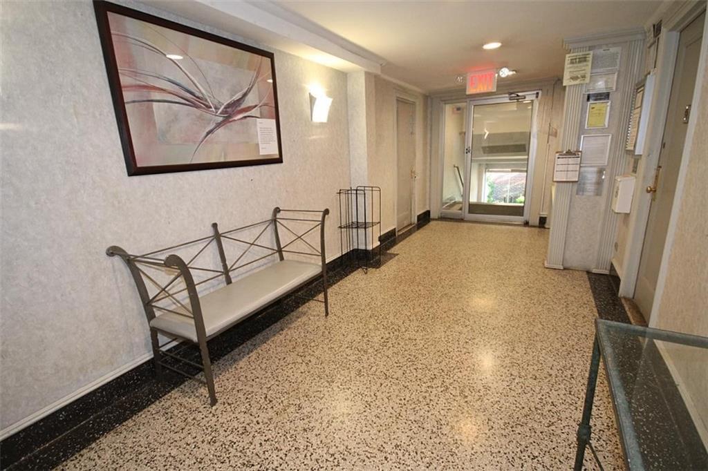 7259 Shore Road, Unit 5A Brooklyn, NY 11209 - Photo 4 of 18 a view of a hallway with a wooden door