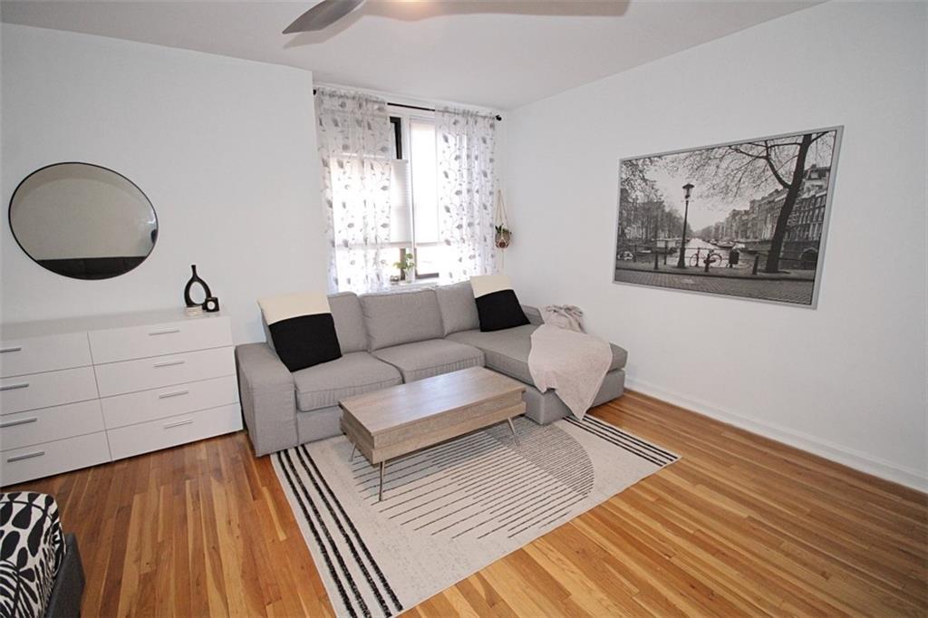 7259 Shore Road, Unit 5A Brooklyn, NY 11209 - Photo 8 of 18 a living room with furniture and a rug