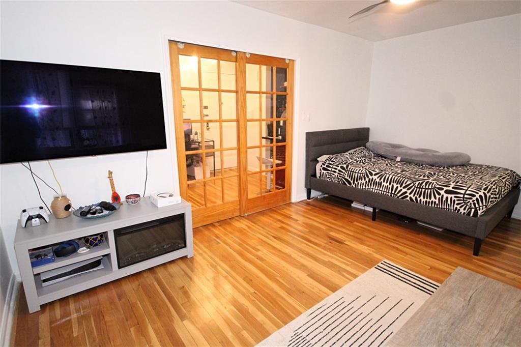 7259 Shore Road, Unit 5A Brooklyn, NY 11209 - Photo 10 of 18 a bedroom with a bed and a flat screen tv