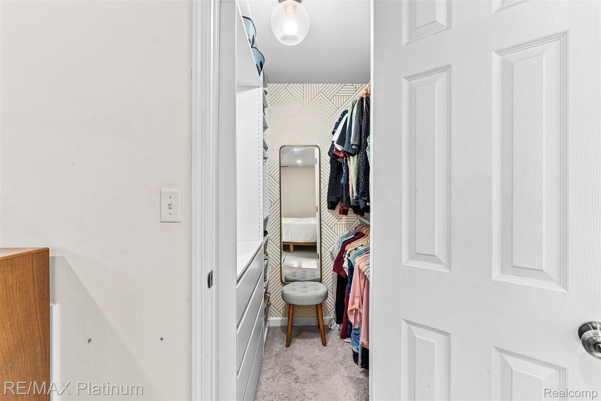 815 Oak Ridge Court Brighton, MI 48116 - Photo 21 of 37 Recessed closet with built-in shelving, drawers, and carpet flooring