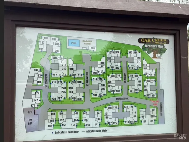 a front view of a multi story building with a yard