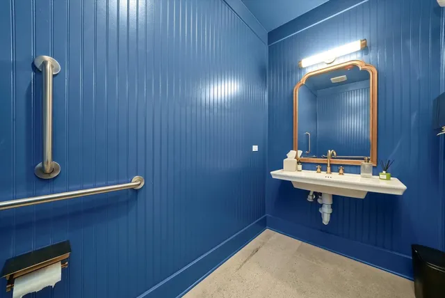 a work place with a large window and wooden floor