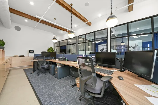 a view of a refrigerator in kitchen and an empty room
