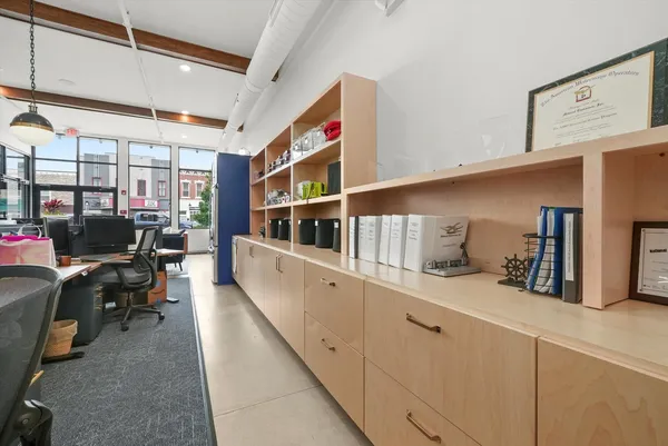 a bedroom with a bed couch and a large window