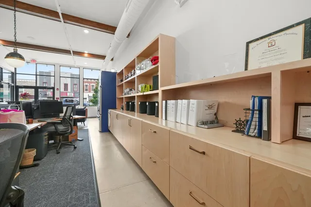 a bedroom with a bed couch and a large window