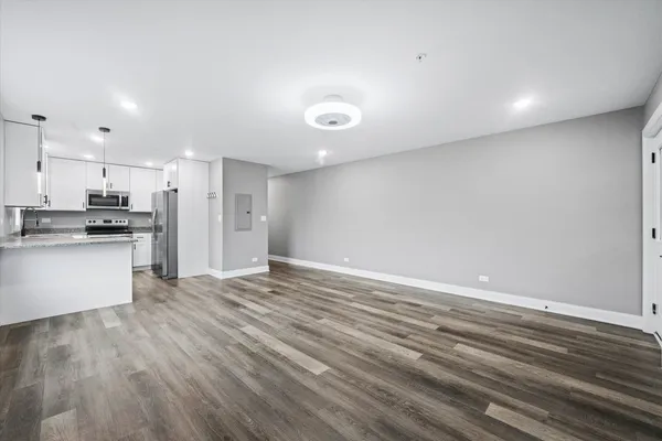 a view of an empty room and wooden floor
