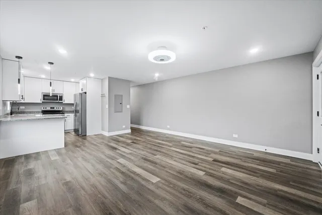 a view of an empty room and wooden floor