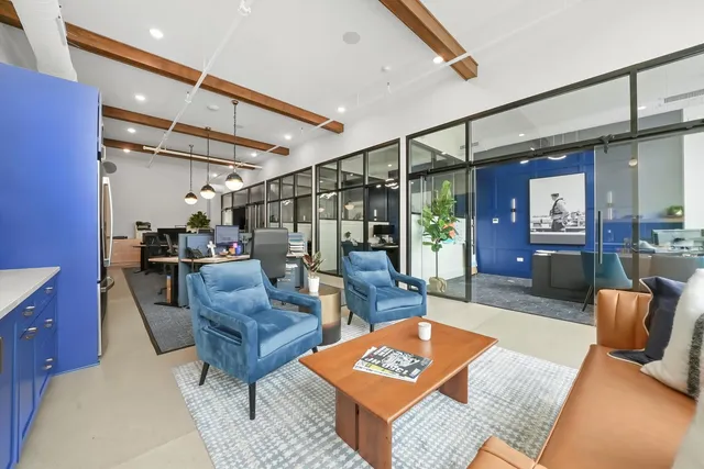a living room with furniture a dining table and a fireplace