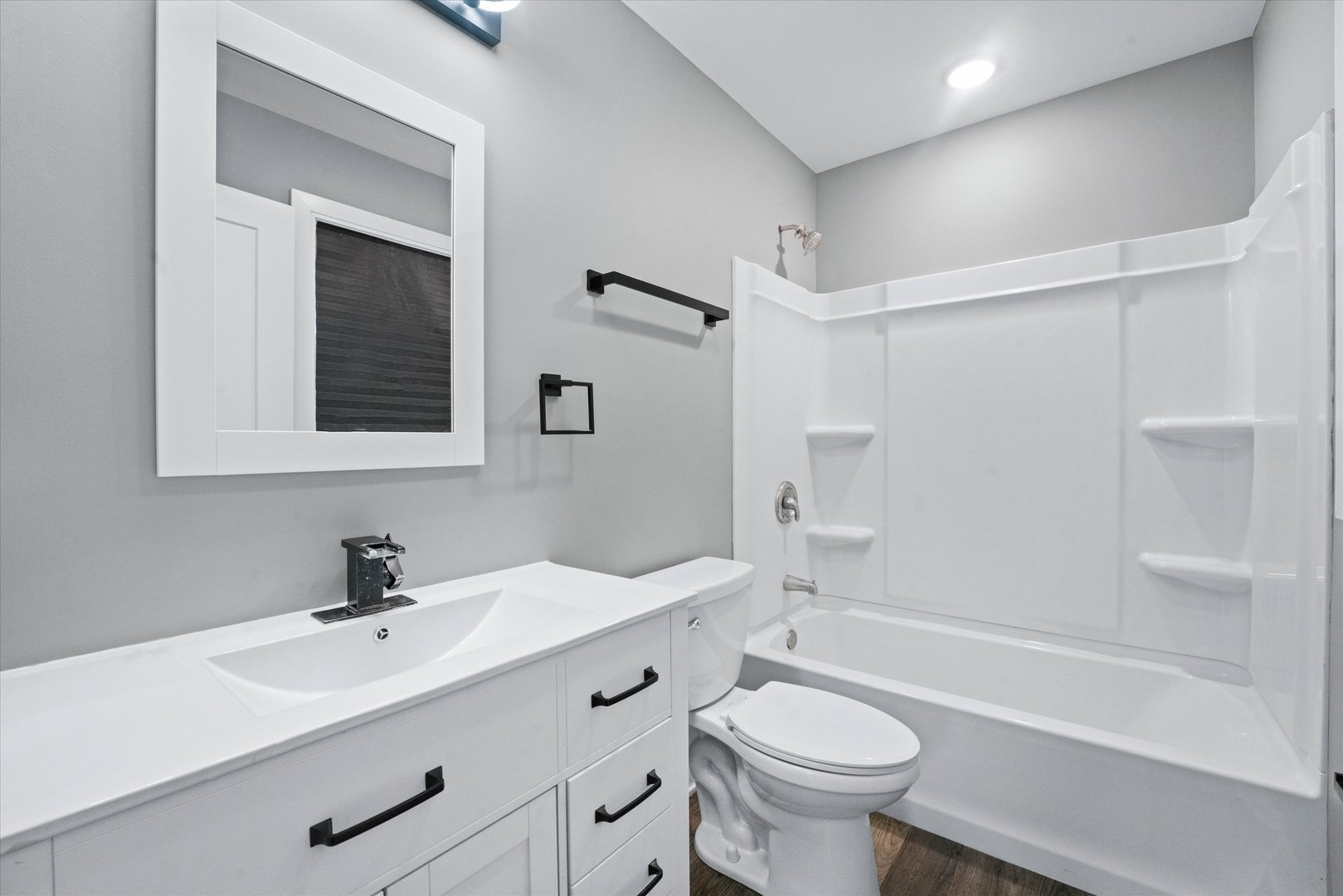 1016 South State Street Lockport, IL 60441 - Photo 45 of 67 a bathroom with a sink a toilet a mirror and shower