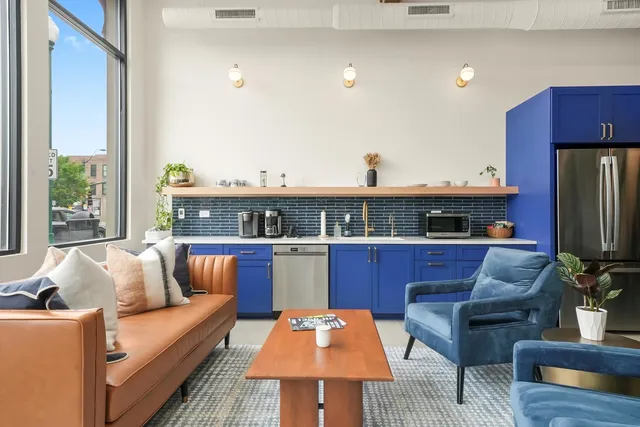 a living room with furniture a view of the kitchen