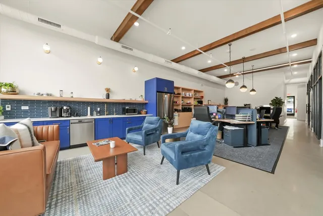 a living room with furniture and a floor to ceiling window