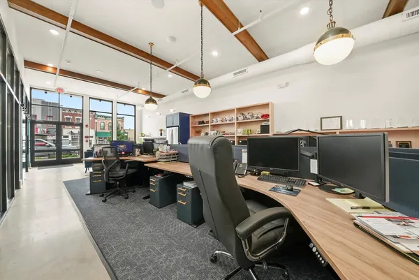 a room with furniture a large window and wooden floors