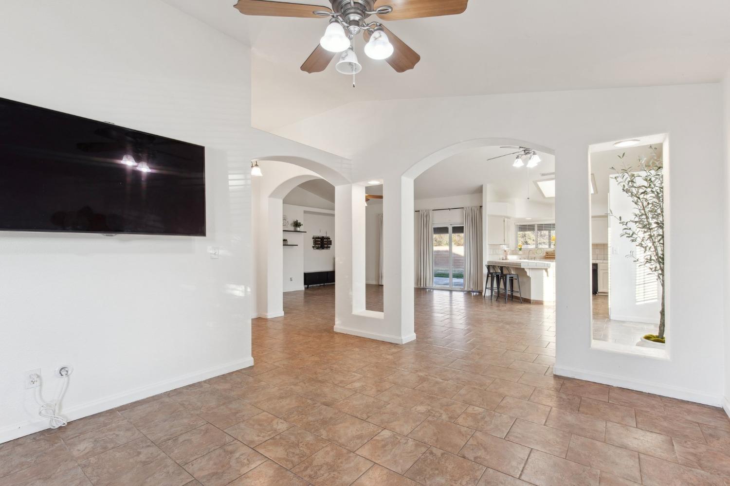 257 Toschi Drive Madera, CA 93637 - Photo 6 of 40 a view of a livingroom with a furniture chandelier fan and kitchen view