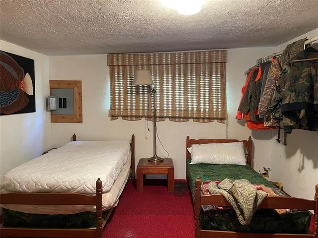 a bedroom with a bed and a mirror