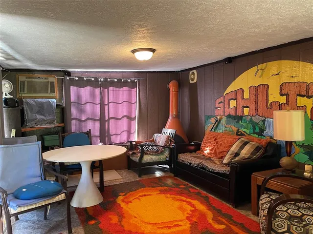 a living room with furniture and a pool table