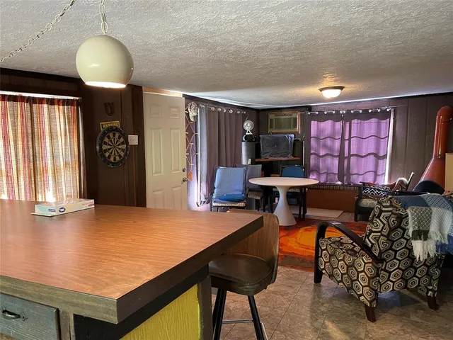 a room with furniture pool table and window