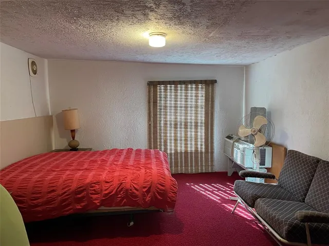 a bedroom with a bed and window