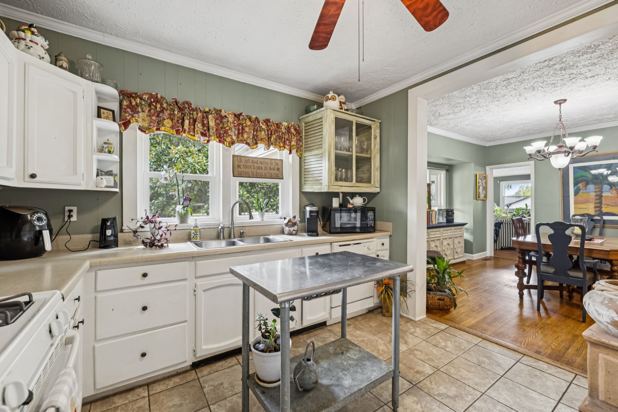 701 Hafner Road Charlotte, TN 37036 - Photo 19 of 52 a kitchen with sink cabinets and dining table