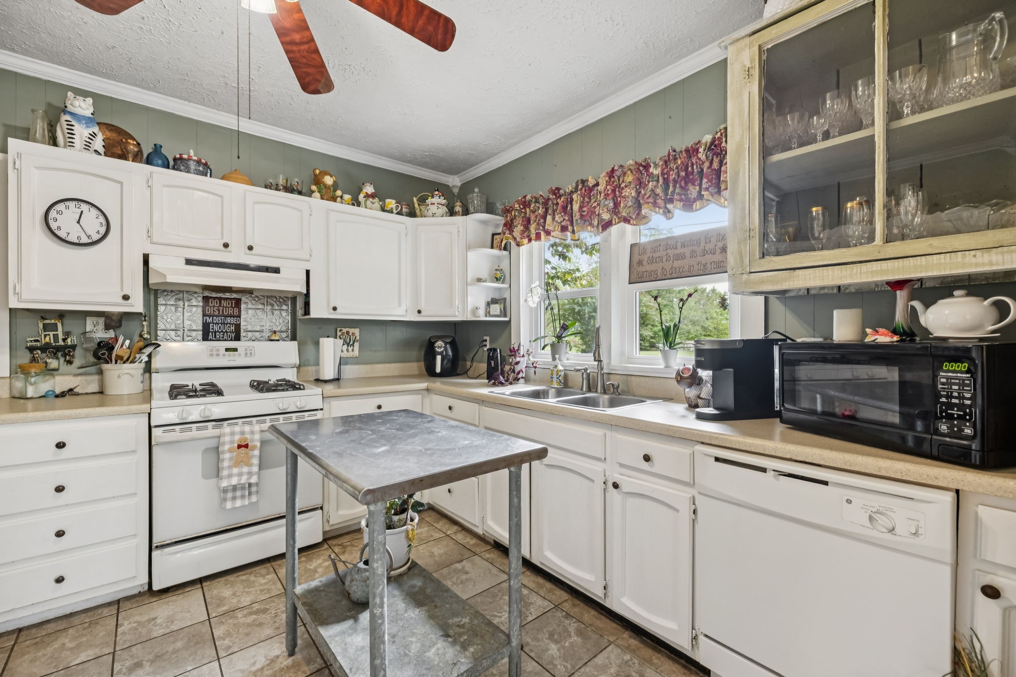 701 Hafner Road Charlotte, TN 37036 - Photo 20 of 52 a kitchen with appliances cabinets and a window