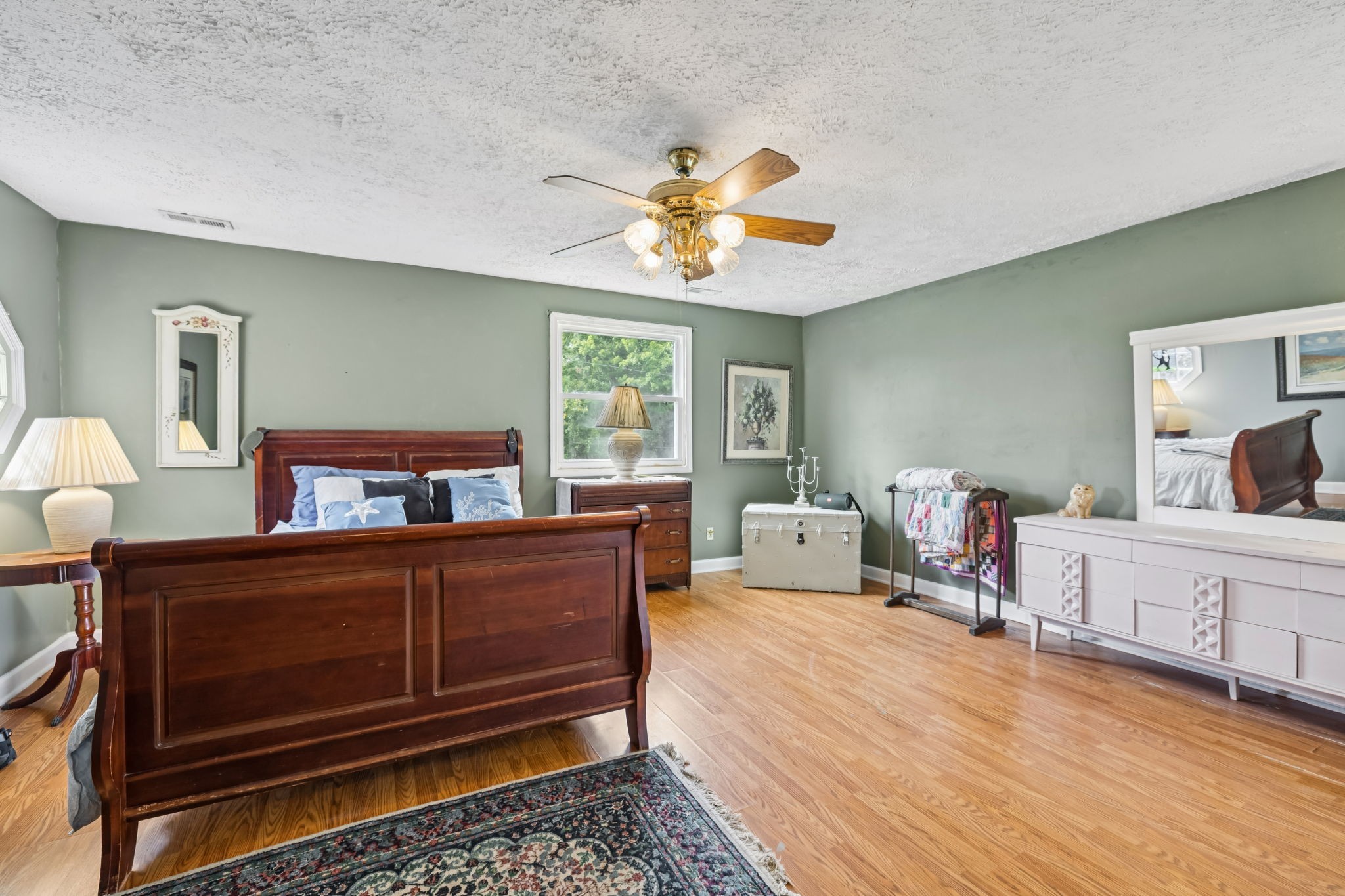 701 Hafner Road Charlotte, TN 37036 - Photo 34 of 52 a bedroom with a bed and wooden floor
