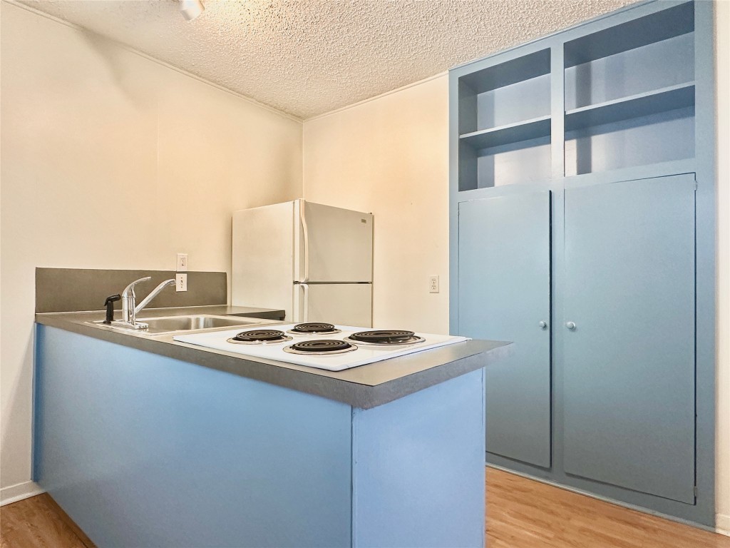 2711 Hemphill Park, Unit A Austin, TX 78705 - Photo 4 of 8 a kitchen with cabinets and appliances