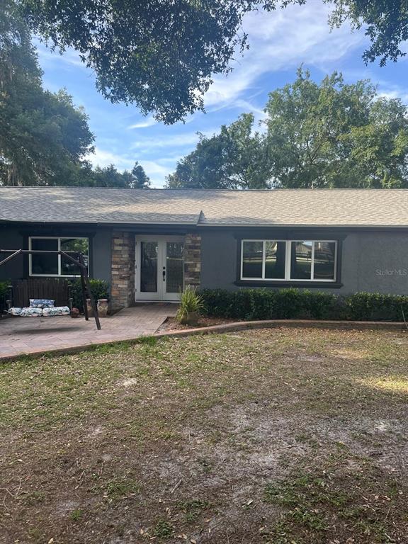 2700 Southeast 157th Lane Road Summerfield, FL 34491 - Photo 2 of 13 front view of a house with a patio