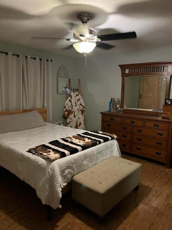 2700 Southeast 157th Lane Road Summerfield, FL 34491 - Photo 3 of 13 a bedroom with a bed and a dresser