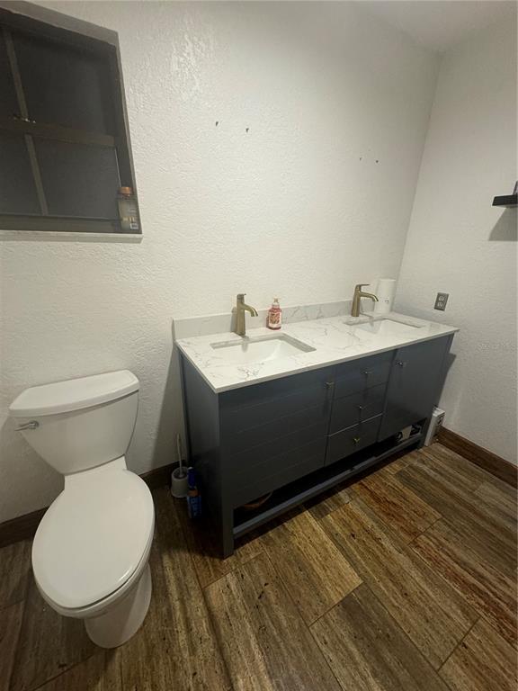 2700 Southeast 157th Lane Road Summerfield, FL 34491 - Photo 4 of 13 a bathroom with a toilet sink and mirror