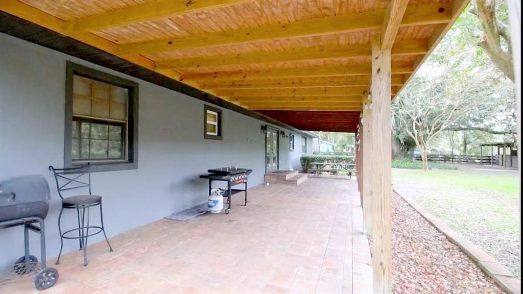 2700 Southeast 157th Lane Road Summerfield, FL 34491 - Photo 6 of 13 a backyard of a house with table and chairs