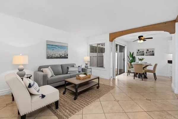 a living room with furniture and a potted plant