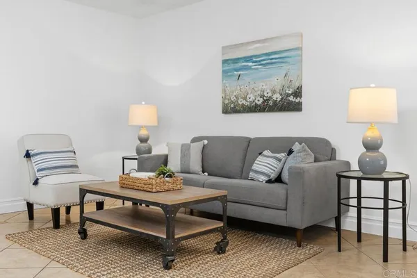 a living room with furniture and a lamp