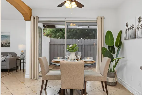 a dining room with furniture a potted plant and a rug