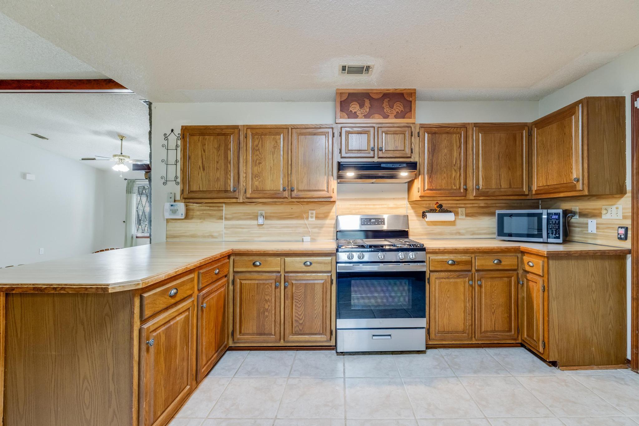 6359 Shangri La Road Crestview, FL 32539 - Photo 13 of 56 a kitchen with stainless steel appliances granite countertop a sink and cabinets