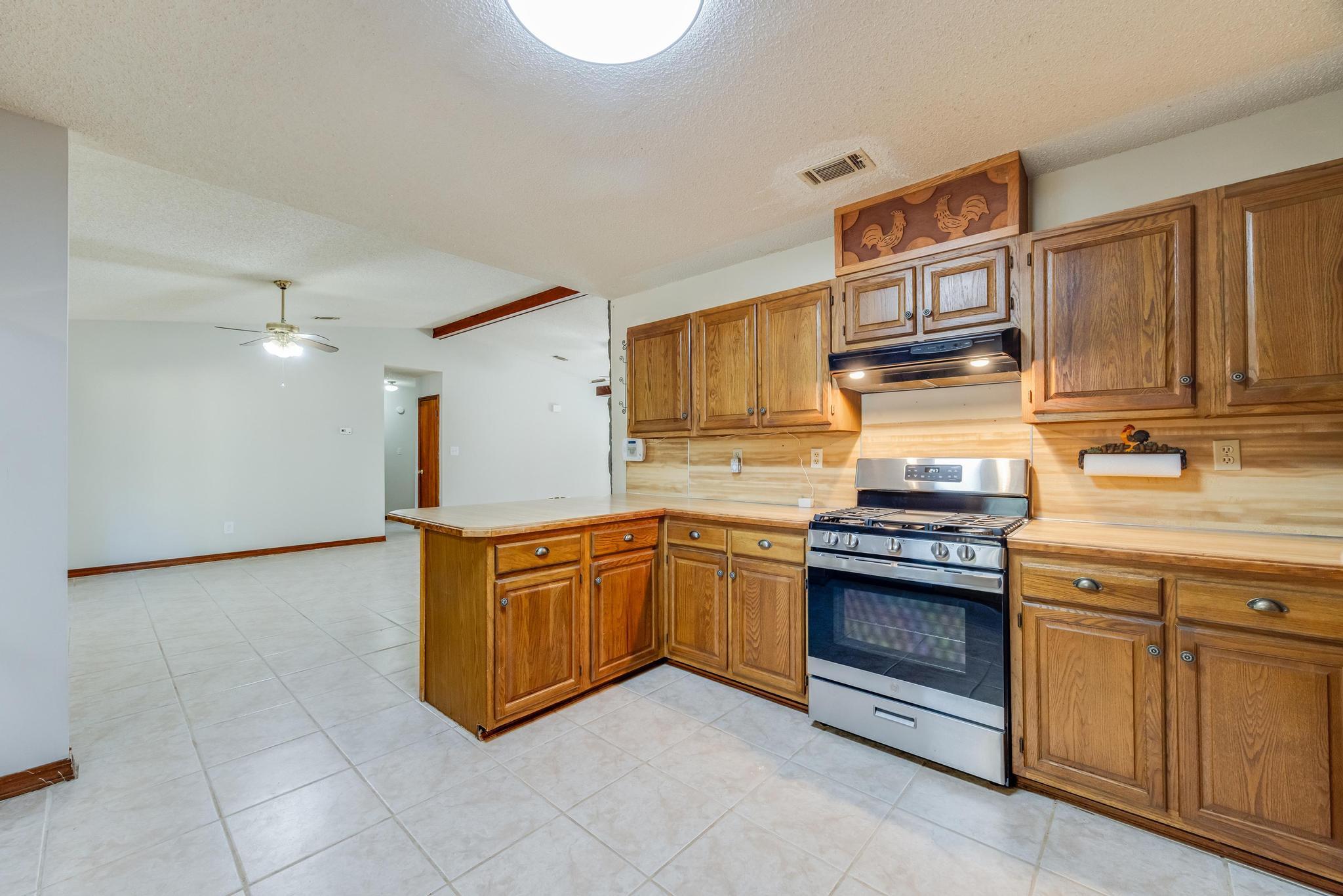 6359 Shangri La Road Crestview, FL 32539 - Photo 15 of 56 a kitchen with stainless steel appliances granite countertop a stove and a sink
