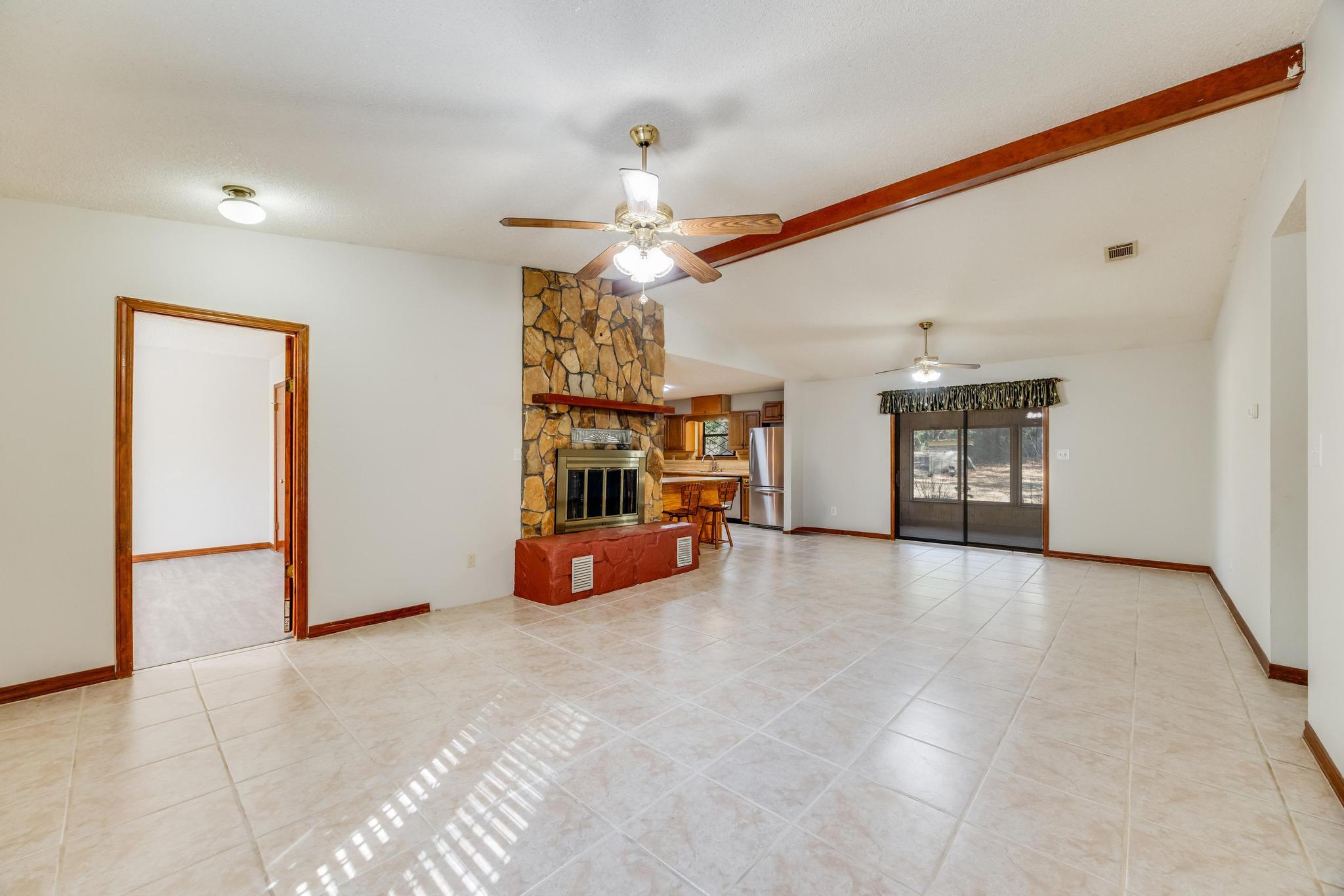 6359 Shangri La Road Crestview, FL 32539 - Photo 18 of 56 a view of a livingroom with a ceiling fan and window
