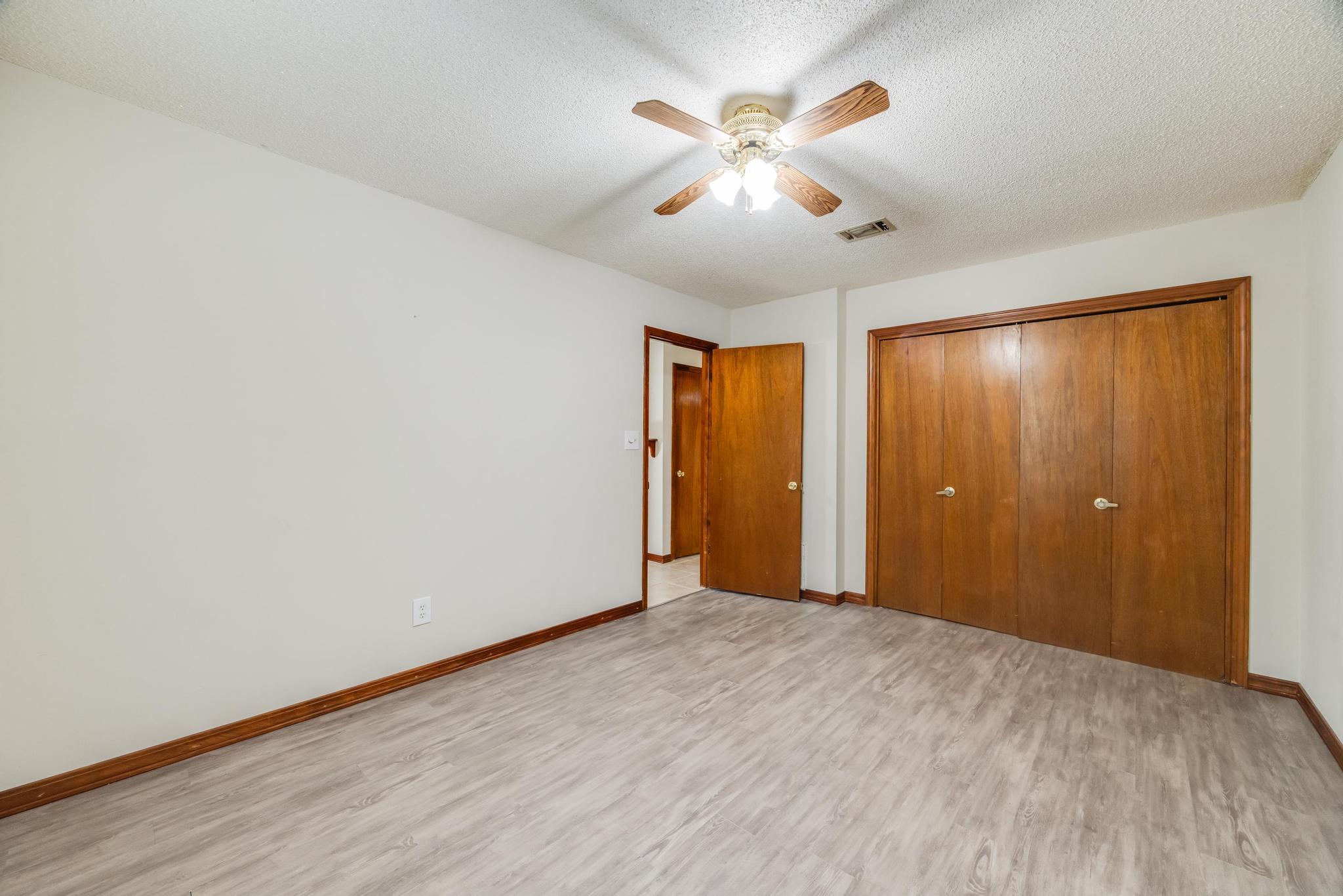 6359 Shangri La Road Crestview, FL 32539 - Photo 35 of 56 a view of empty room with wooden floor and ceiling fan