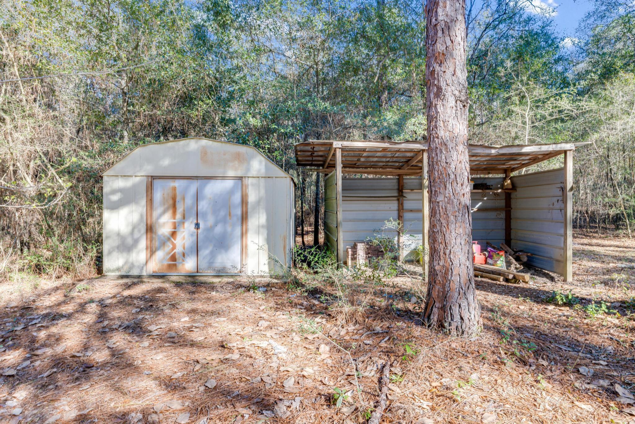 6359 Shangri La Road Crestview, FL 32539 - Photo 47 of 56 a backyard of a house with lots of green space