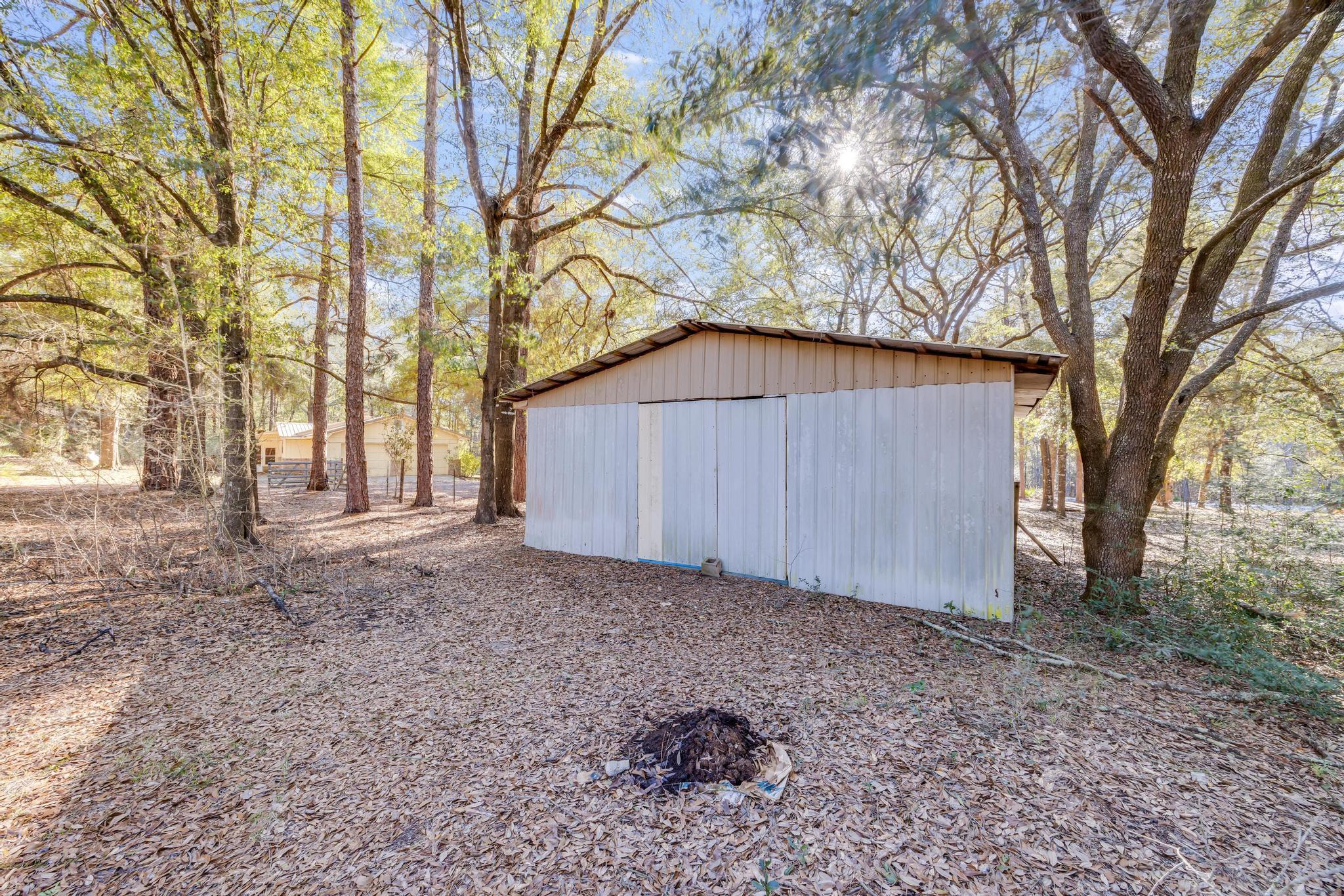 6359 Shangri La Road Crestview, FL 32539 - Photo 48 of 56 a backyard of a house with lots of green space