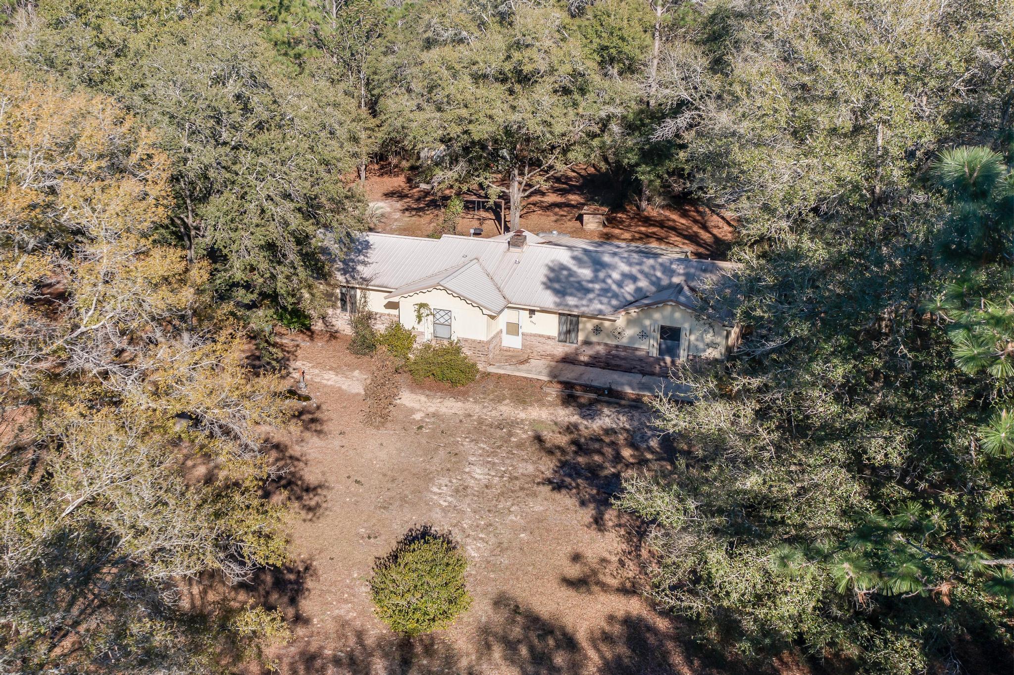 6359 Shangri La Road Crestview, FL 32539 - Photo 52 of 56 a view of a yard with trees