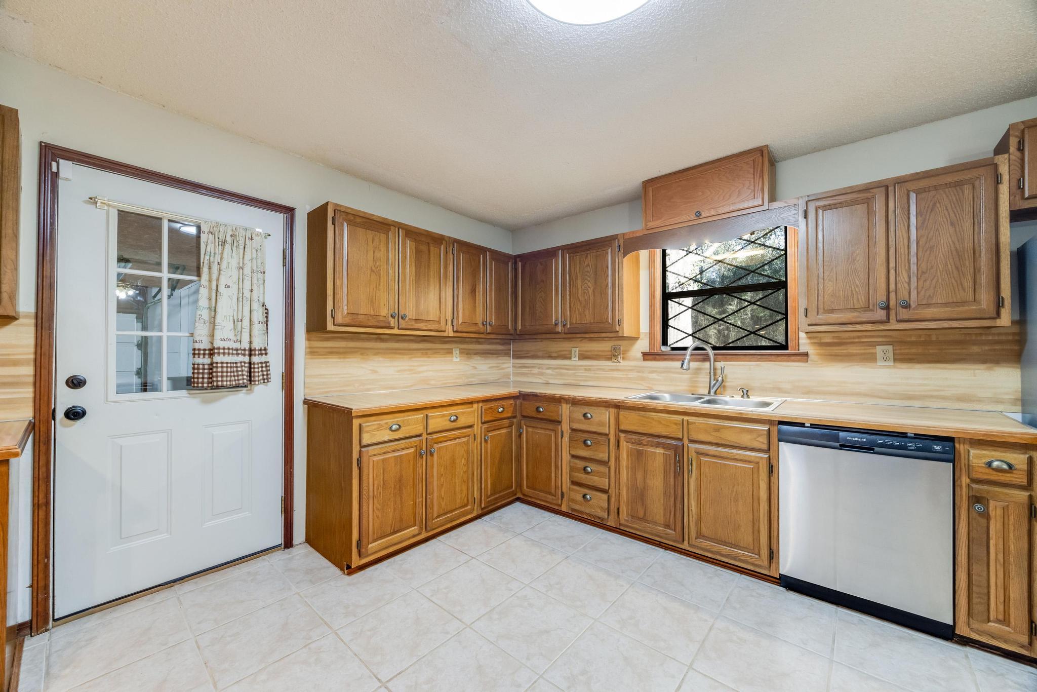 6359 Shangri La Road Crestview, FL 32539 - Photo 7 of 56 a kitchen with granite countertop sink and cabinets