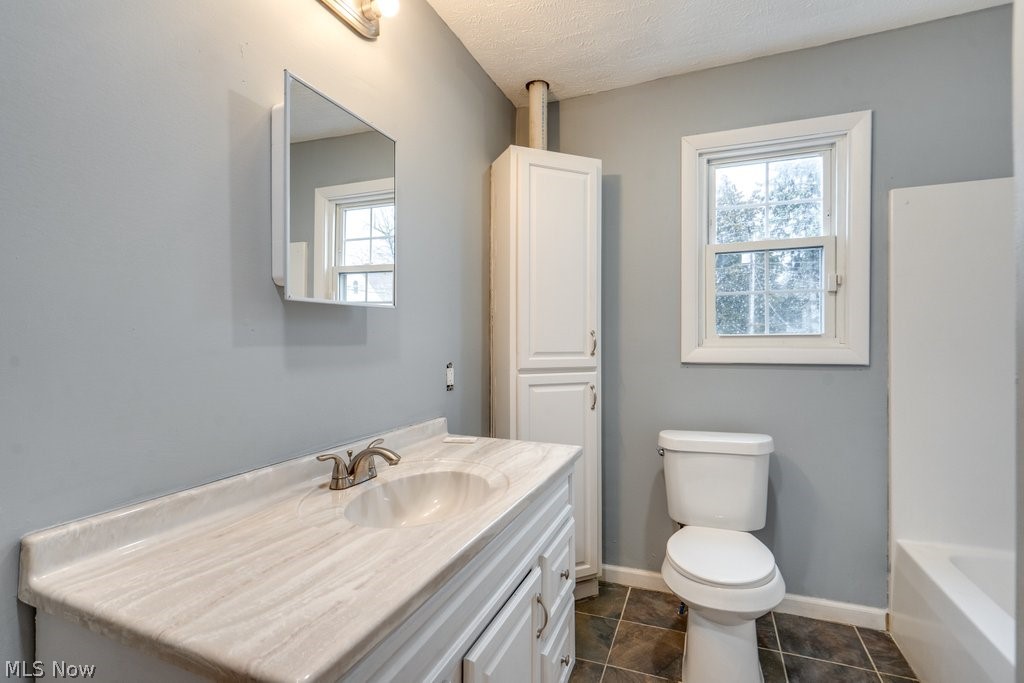 1607 9th Street Southwest Canton, OH 44706 - Photo 29 of 41 Bathroom featuring a white vanity with an integrated sink, brushed nickel faucet, and a white medicine cabinet