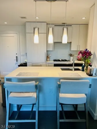 a kitchen with a table chairs sink and cabinets