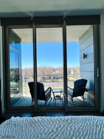 a living room with furniture and large windows
